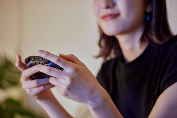 居間でゲームをしている日本の若い女性 - hobbies ストックフォトと画像