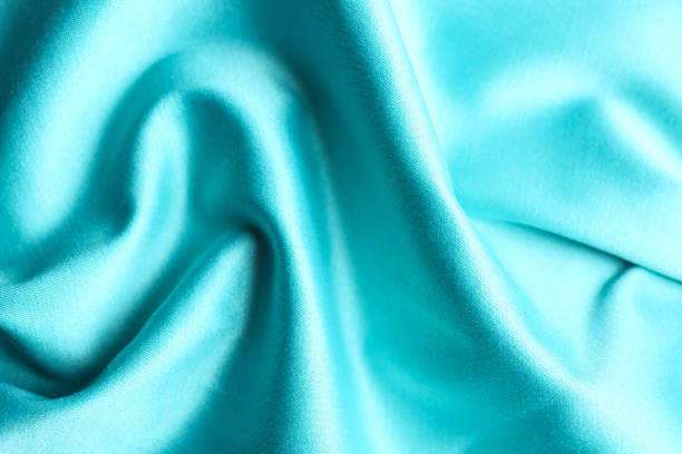istock Texture of delicate light blue fabric as background, closeup 1340890830