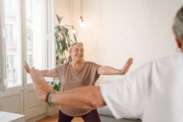 istock Senior couple doing yoga at home 1340890898