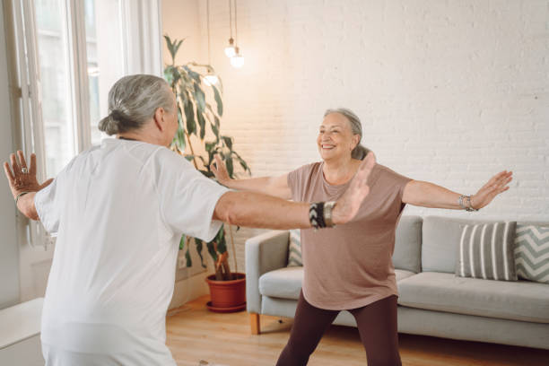 istock Senior couple doing yoga at home 1340890943
