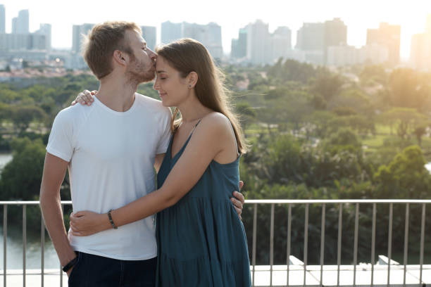 istock Man Hugging Girlfriend and Kissing on Forehead 1340892834