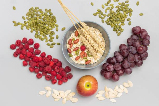 istock Nuts, oatmeal and wheat spikelets in gray bowl. 1340893053