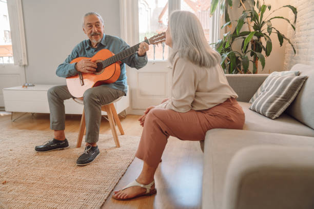 istock Man playing guitar at home 1340893102