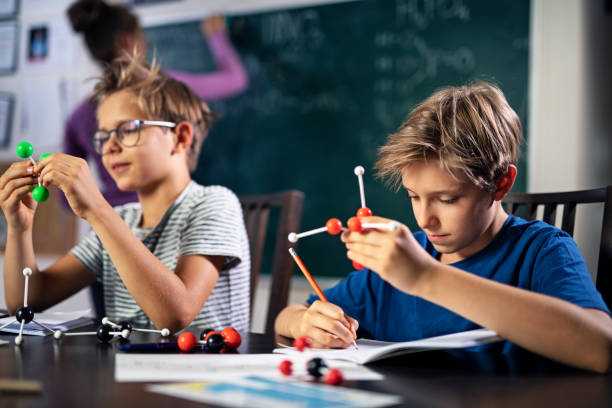 istock Little boys attending to chemistry lesson 1340893339