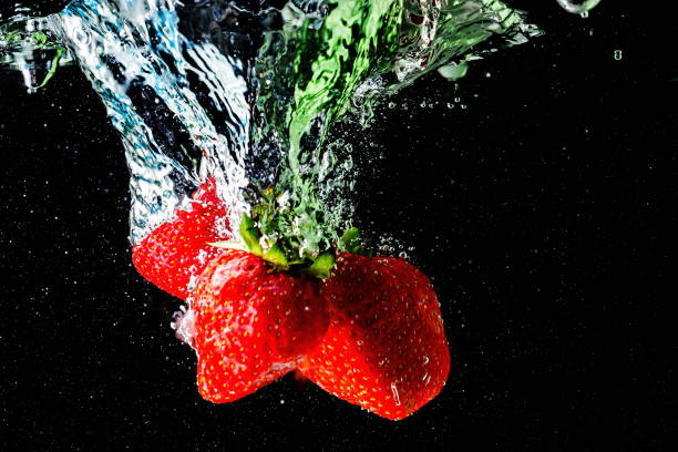 istock ripe strawberries fall into the water lifting splashes and air bubbles 1340893343