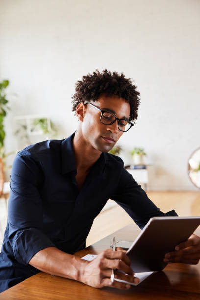 istock Young African American designer working on a tablet in an office 1340893405