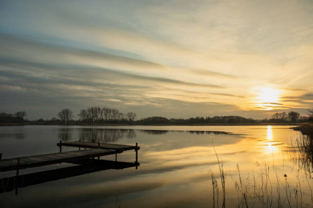 istock Sunset with cool clouds over the lake 1340894436