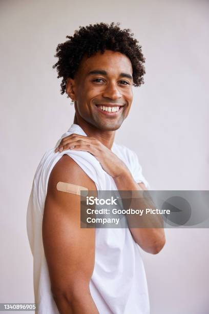 Smiling African American Man With A Bandage On His Arm After A Covid19 Vaccination Stock Photo - Download Image Now