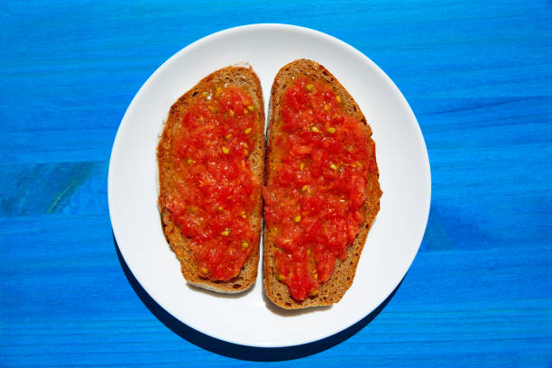 istock Bread toasted slices with grated tomato 1340897781