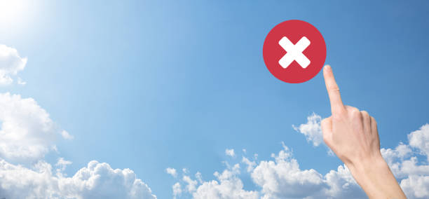 istock Hand holds icon,cancellation symbol,cancel icon.Cross mark flat red icon.round X mark.cancel button.Wrong.cross mark rejection.Declined.On dark background.Banner.Copy space.Place for text. 1340900896