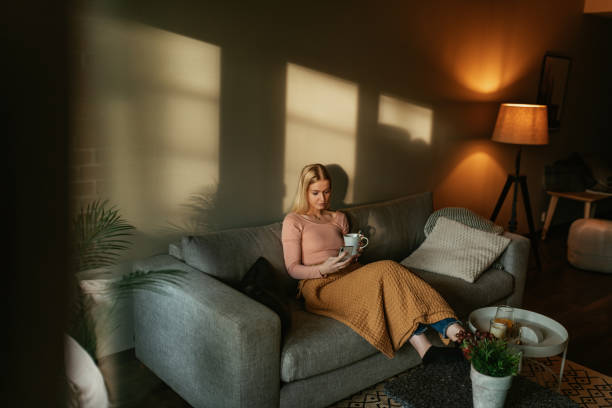 istock Blonde Generation Z women lying on couch and using phone 1340909083