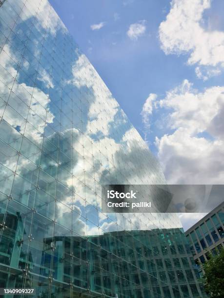 Reflection Of Blue Sky And Clouds On The Glass Facade Of Modern Buildings In The Spinningfields District Of Manchester Uk Stock Photo - Download Image Now