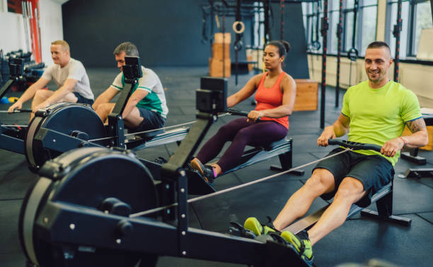 istock Sports team exercising on rowing machines in gym 1340909340