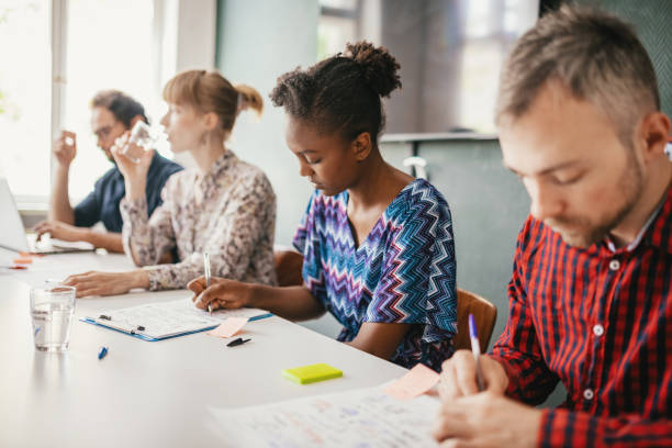 istock Candidates for job filling out documents 1340912128
