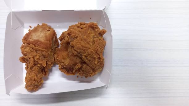 istock Kentucky fried chicken in white cardboard box on white table. Top view, overhead. Close-up. 1340916505