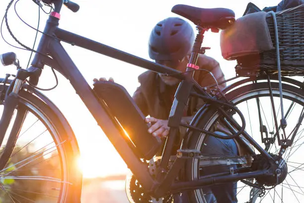 biker inserting electric bike battery