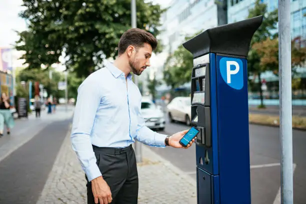 Photo of Business person paying parking in the city