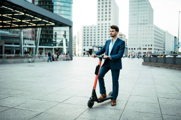 Commuter using e-scooter in the city stock photo