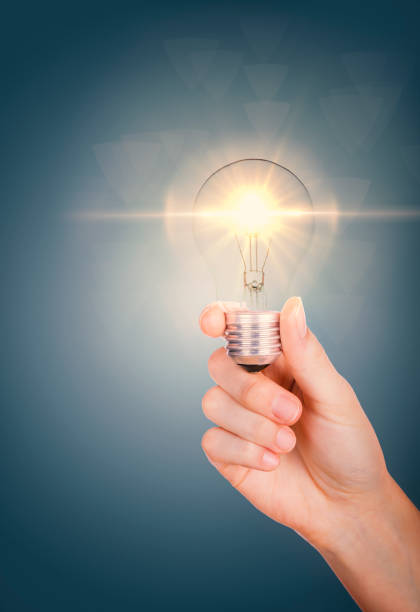 istock Young woman hand holding lightning bulb 1340920234