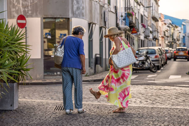 Middle aged couple discussing shoes in Ponta Delgada which is the main city on the Portuguese Azorean Island San Miguel in the center of the North Atlantic Ocean.