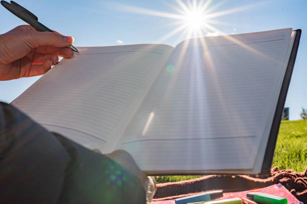 Unrecognizable woman learning during sunny day outdoors