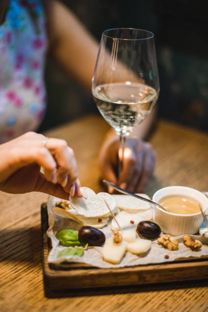 istock Cheese plate with a glass of white wine 1340927900