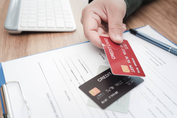 istock Close up hand a man hold credit cards 1340928200
