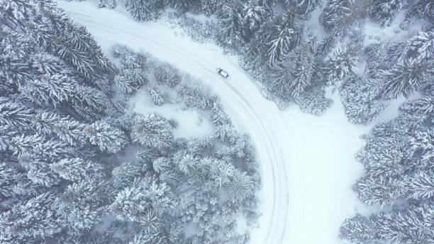 istock Car driving on winter country road 1340928233