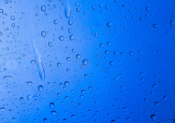 istock Rain drops on the glass blue color for texture and background 1340928282