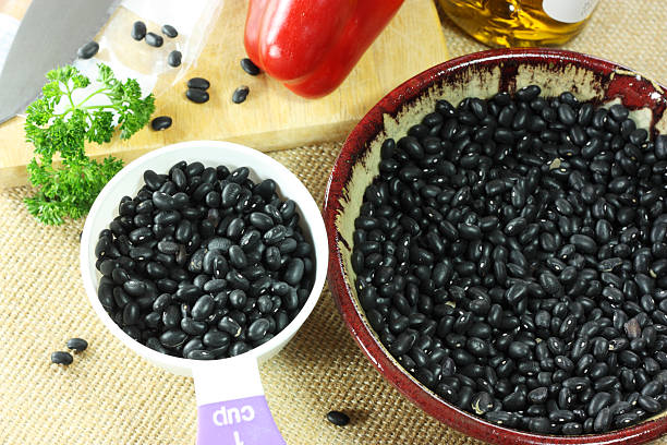 Dried black beans A cup of dried black beans Cup of Black Beans stock pictures, royalty-free photos & images