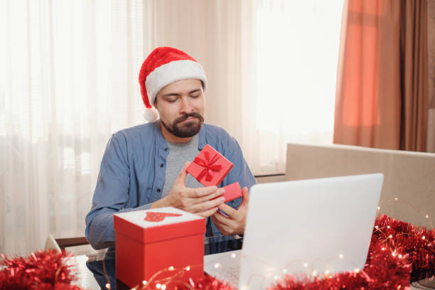 istock hipster man with red cup sitting home at Christmas time. 1340929090