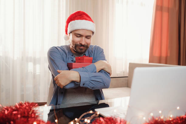 istock hipster man with red cup sitting home at Christmas time. 1340929119