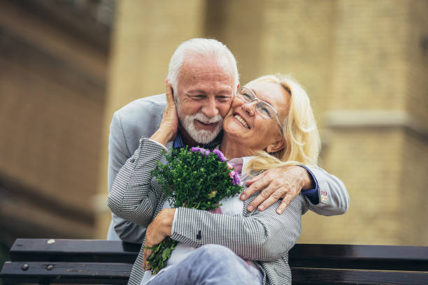 istock Romantic middle-aged man giving his wife flowers 1340929202