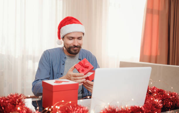 istock hipster man with red cup sitting home at Christmas time. 1340930306