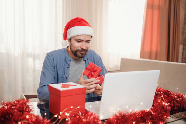 istock hipster man with red cup sitting home at Christmas time. 1340930452