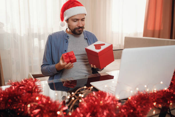 istock hipster man with red cup sitting home at Christmas time. 1340930481