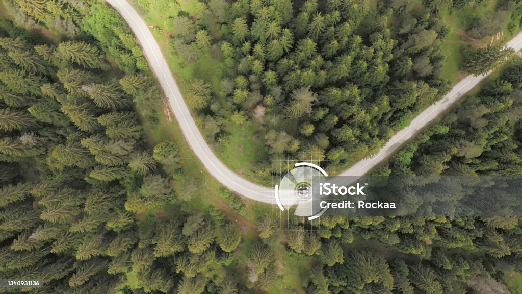 Car tracked by satellite Aerial view of the car followed by satellite Drone Stock Photo