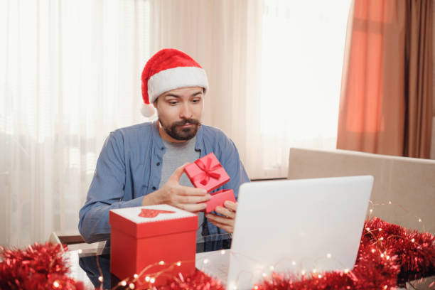istock hipster man with red cup sitting home at Christmas time. 1340931962