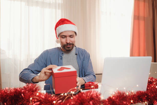 istock hipster man with red cup sitting home at Christmas time. 1340931972