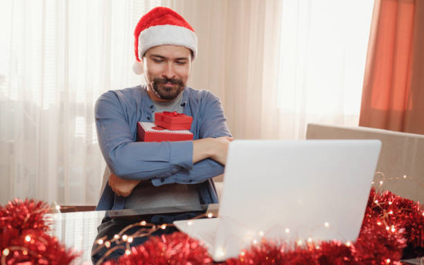 istock hipster man with red cup sitting home at Christmas time. 1340931998