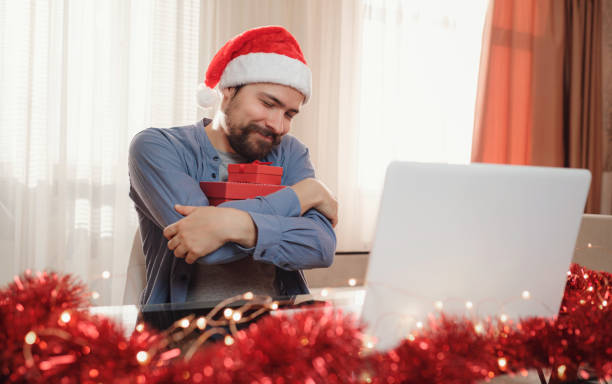 istock hipster man with red cup sitting home at Christmas time. 1340932014