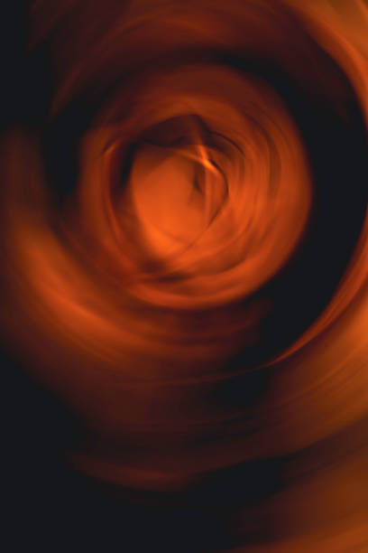 istock Abstract blurred geometric spinning motion background in orange and black colors 1340933194