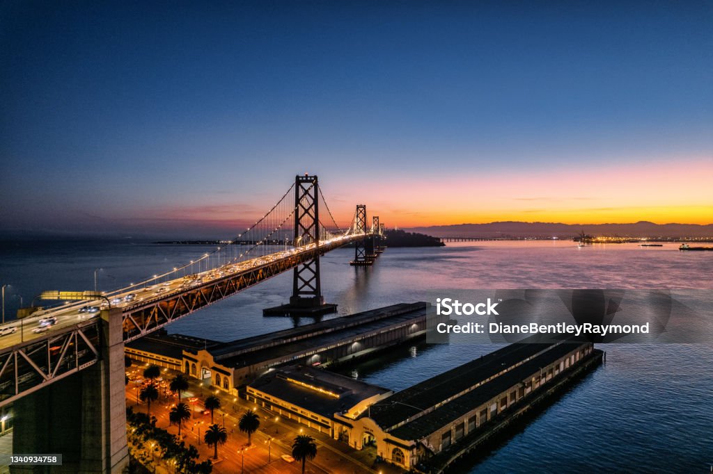 Night Aerial View of Bay Bridge Night time aerial view of the Bay Bridge illuminated with vehicles traveling over the bridge. San Francisco - California Stock Photo