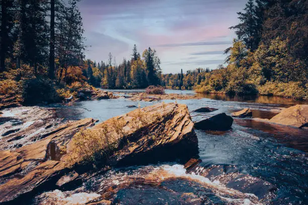 Photo of the current of the river sneaking between the rocks -