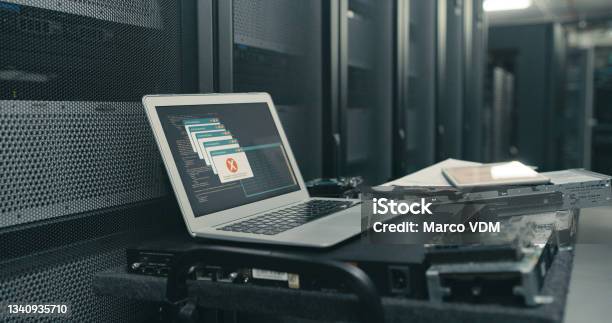 Shot Of A Laptop With An Error Message On The Screen In An Empty Server Room Stock Photo - Download Image Now