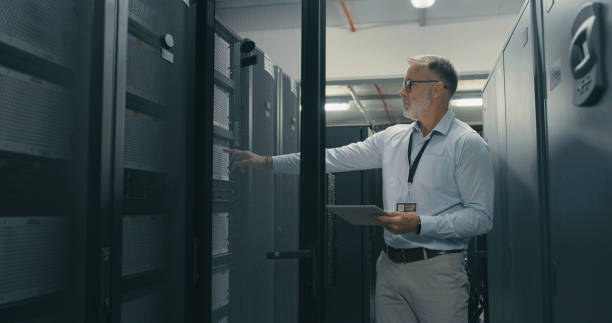 istock Shot of a mature man using a digital tablet while working in a data centre 1340936090