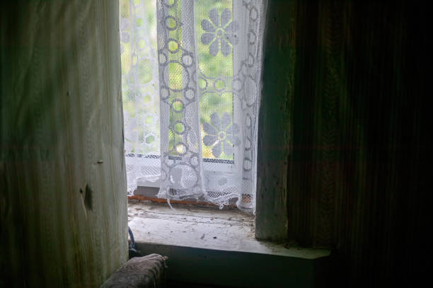 curtains on the window of an old rural house
