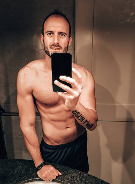 istock shirtless man take a selfie inside the bathroom 1340938976
