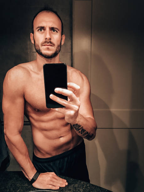 istock shirtless man take a selfie inside the bathroom 1340939069