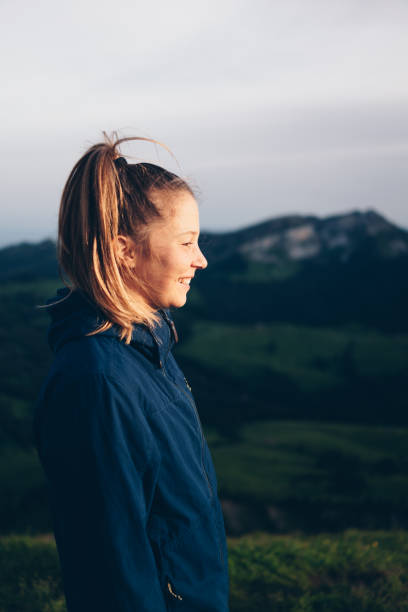 istock Female hiker relaxes on mountain ridge at sunrise 1340940024
